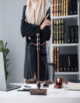 Muslim female lawyer standing with arms crossed inside office